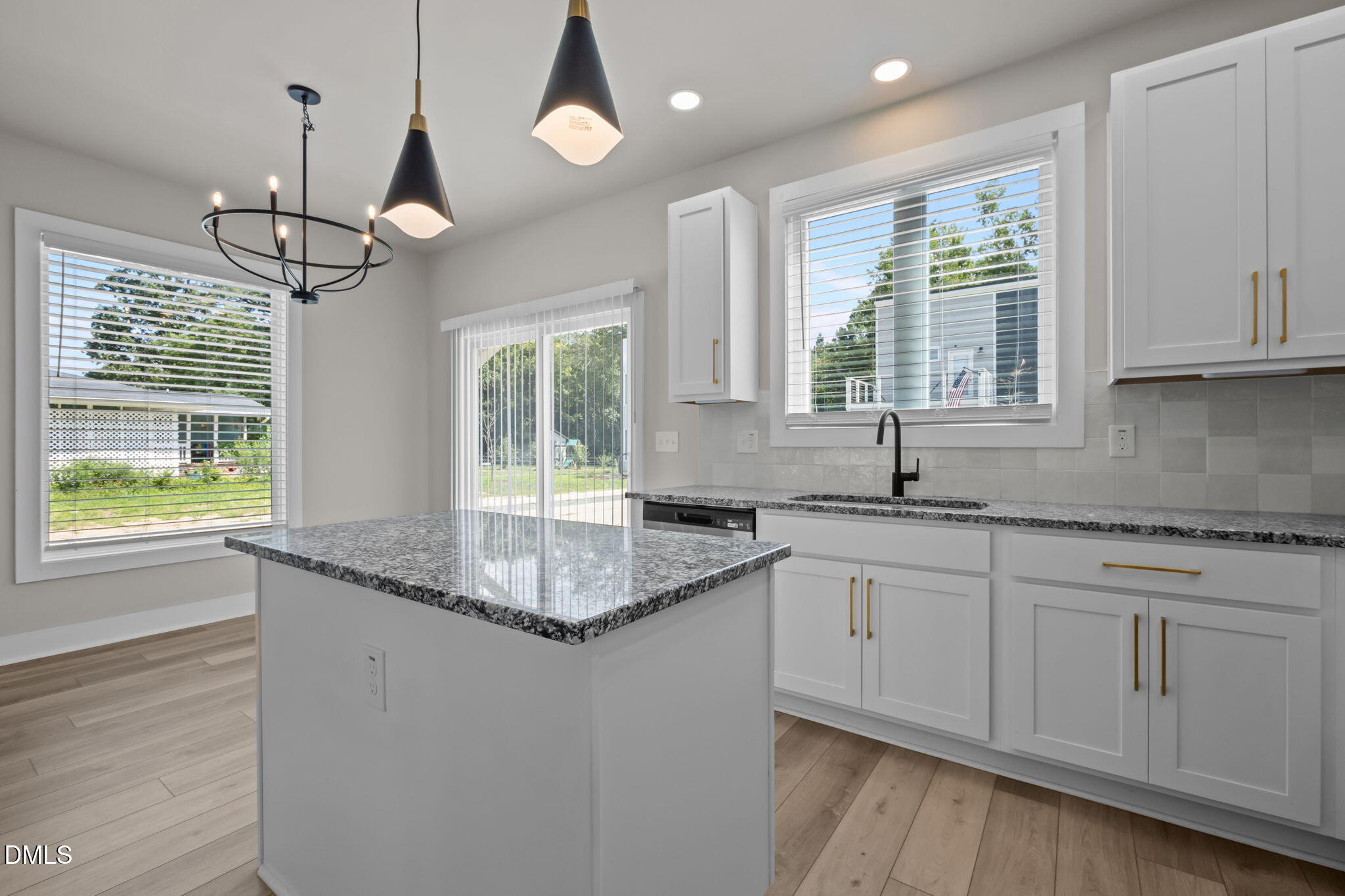 421 Eugene Street, Unit A Durham, NC 27701 - Photo 18 of 38 a kitchen with granite countertop cabinets a window and a sink