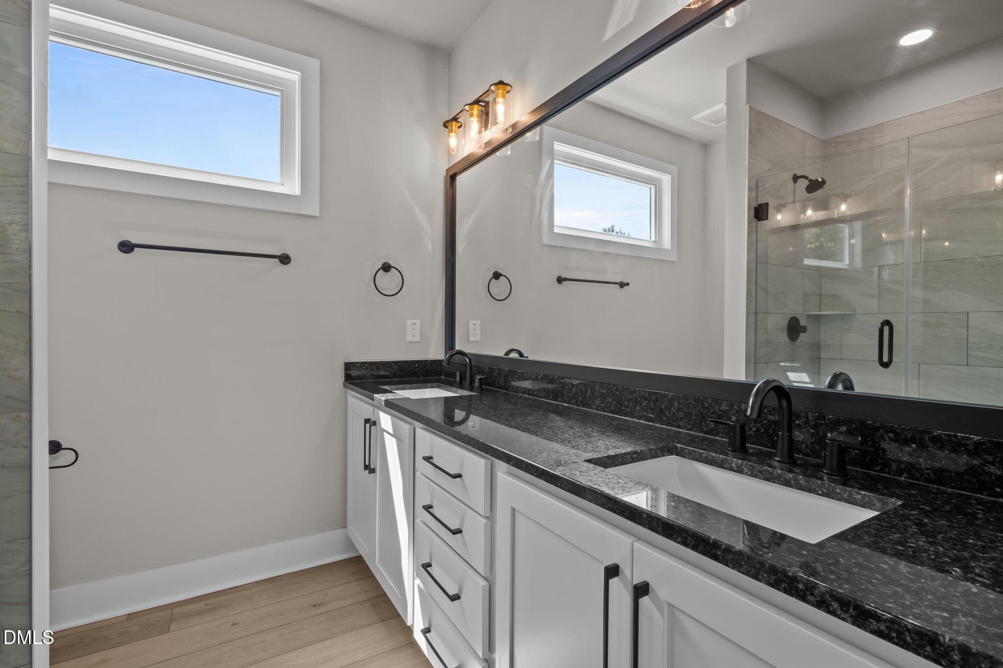 421 Eugene Street, Unit A Durham, NC 27701 - Photo 25 of 38 a bathroom with a granite countertop sink a mirror and a shower