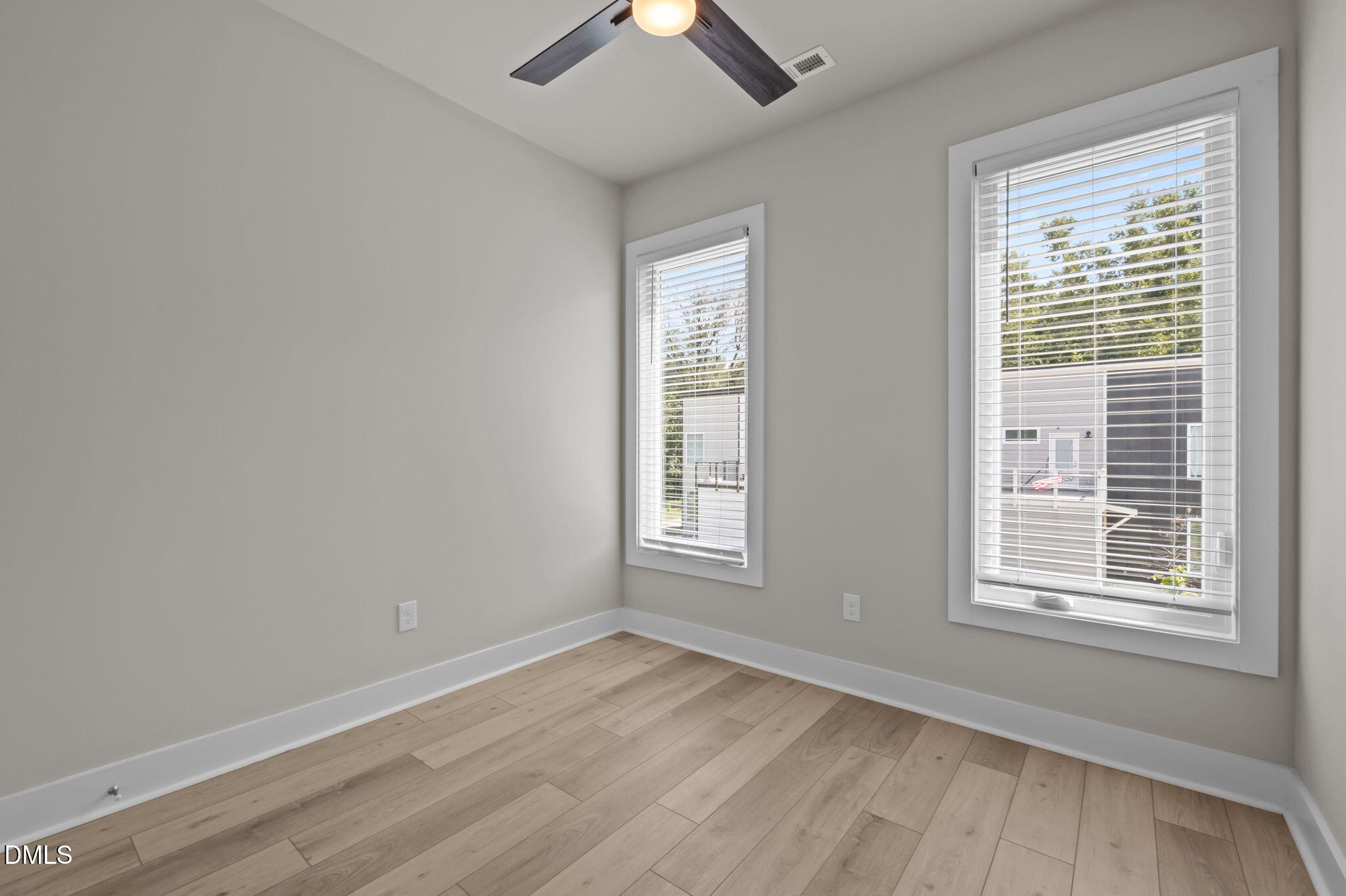 421 Eugene Street, Unit A Durham, NC 27701 - Photo 28 of 38 a view of an empty room with wooden floor and a window