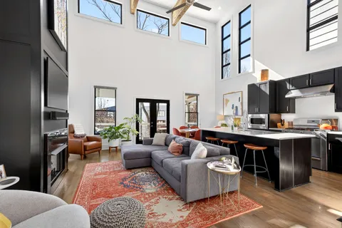 a kitchen with stainless steel appliances granite countertop a stove refrigerator and cabinets