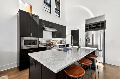 a roof deck with a table and chairs