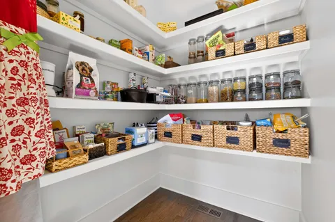 a living room with furniture a chandelier and a window