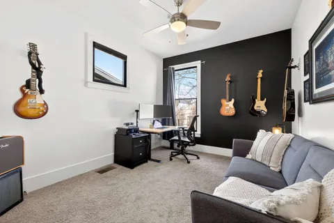 a view of roof deck with couches and wooden floor