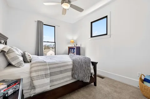 a view of a wooden bench sitting in backyard of house