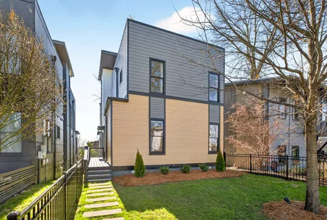 a view of balcony with two chairs and a potted plant