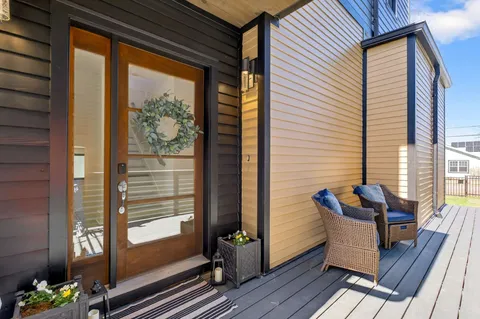 a living room with furniture and a view of kitchen