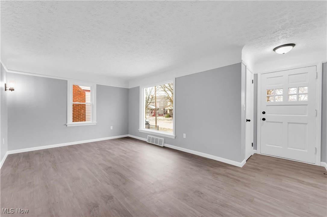 953 Whitby Road Cleveland Heights, OH 44112 - Photo 3 of 27 Foyer entrance with a textured ceiling and light wood-type flooring