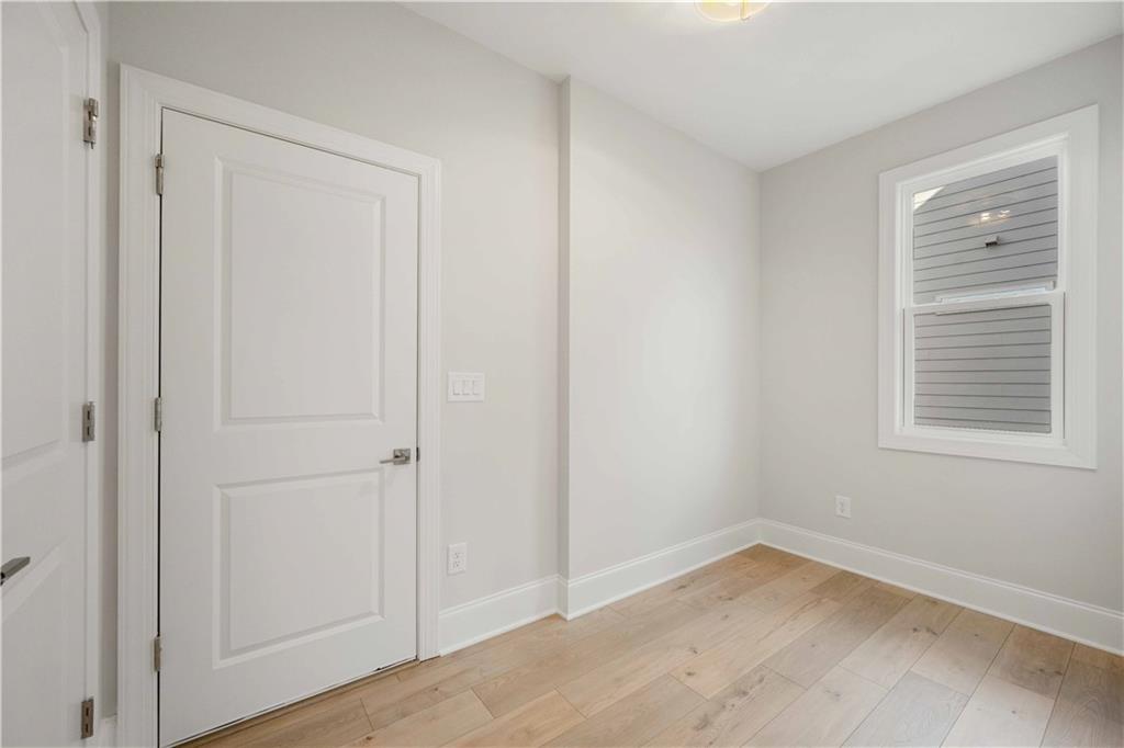 126 Spaulding Lane Woodstock, GA 30188 - Photo 19 of 48 a view of empty room with wooden floor