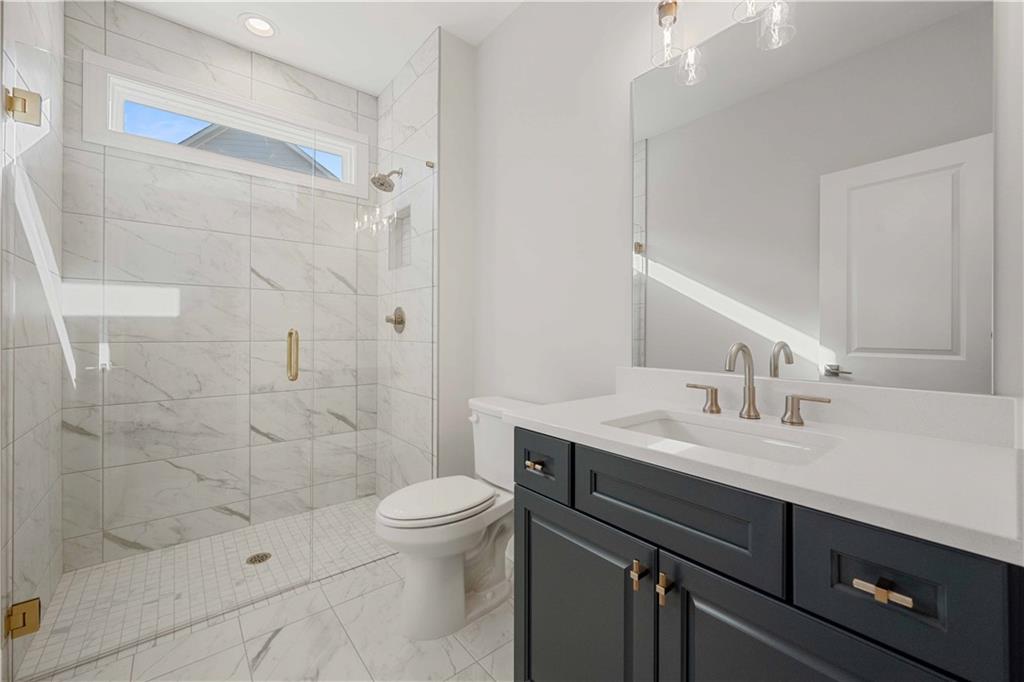 126 Spaulding Lane Woodstock, GA 30188 - Photo 20 of 48 a bathroom with a sink a toilet and shower