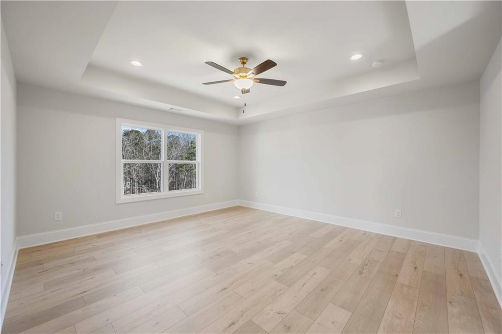 126 Spaulding Lane Woodstock, GA 30188 - Photo 21 of 48 wooden floor in an empty room with a window