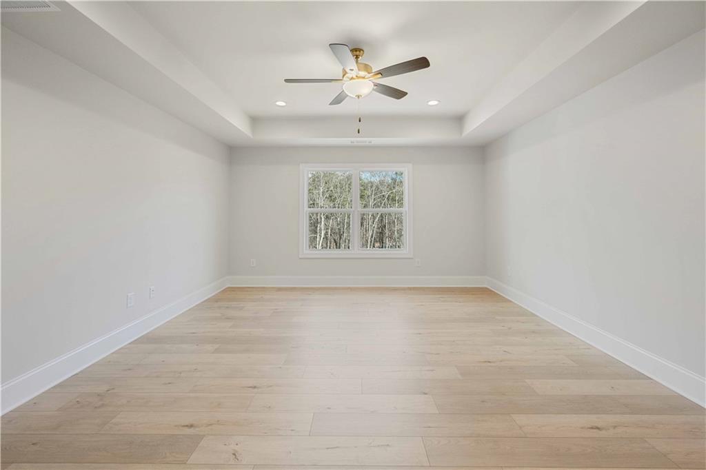 126 Spaulding Lane Woodstock, GA 30188 - Photo 22 of 48 an empty room with windows and ceiling fan