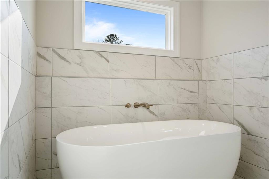 126 Spaulding Lane Woodstock, GA 30188 - Photo 25 of 48 a white bath tub sitting in a bathroom