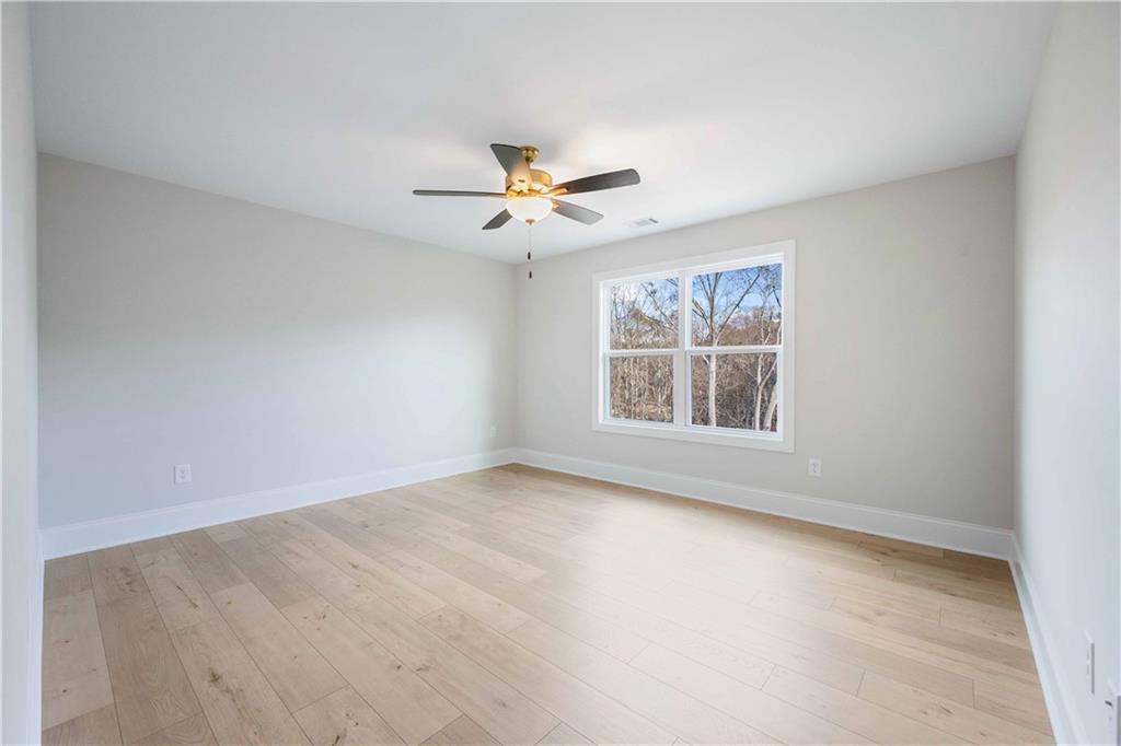 126 Spaulding Lane Woodstock, GA 30188 - Photo 28 of 48 a view of an empty room with a window