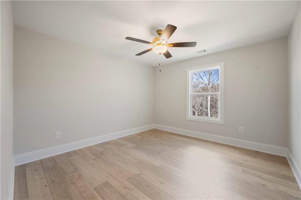 126 Spaulding Lane Woodstock, GA 30188 - Photo 30 of 48 an empty room with a window and a ceiling fan