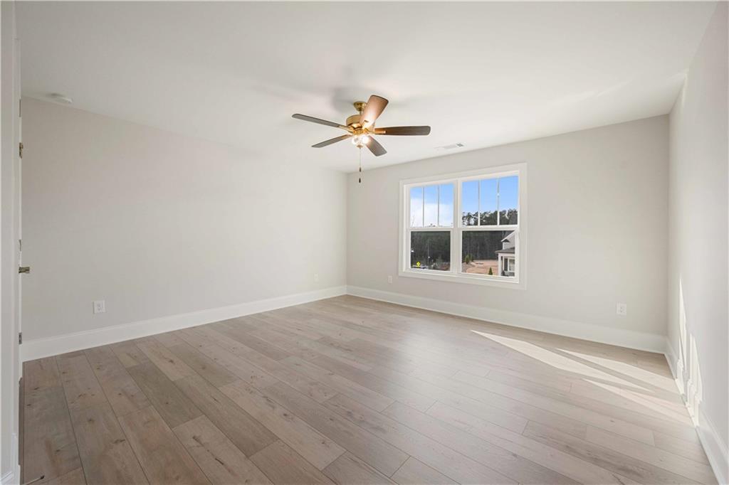 126 Spaulding Lane Woodstock, GA 30188 - Photo 31 of 48 wooden floor that has a window in an empty room