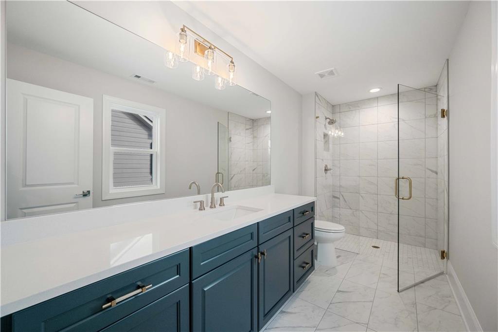 126 Spaulding Lane Woodstock, GA 30188 - Photo 32 of 48 a spacious bathroom with a shower sink mirror and