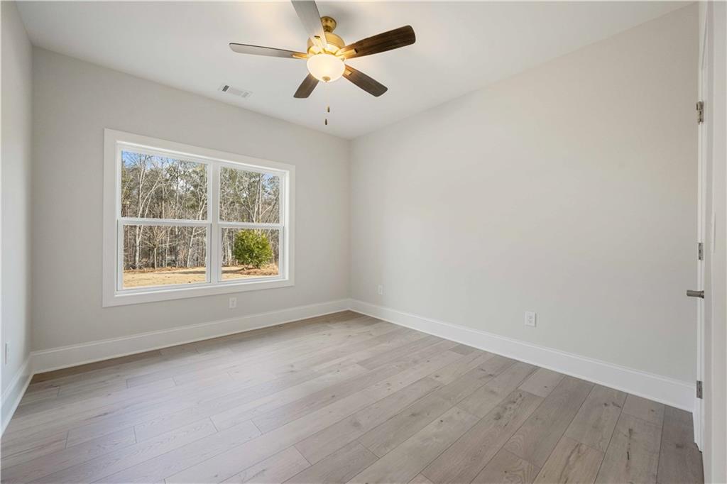 126 Spaulding Lane Woodstock, GA 30188 - Photo 38 of 48 an empty room with a window and a fan