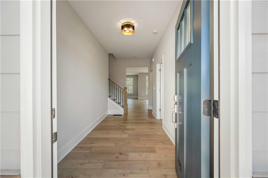 126 Spaulding Lane Woodstock, GA 30188 - Photo 5 of 48 a view of a hallway with wooden floor