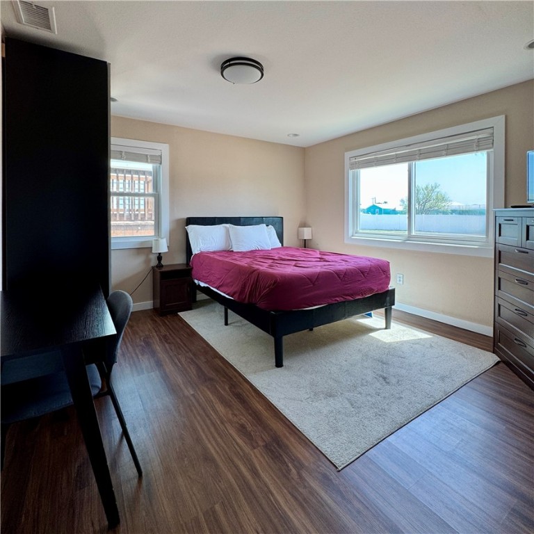 230 Cut-Off Road, Unit B107 Port Aransas, TX 78373 - Photo 18 of 25 a bedroom with a bed and wooden floor