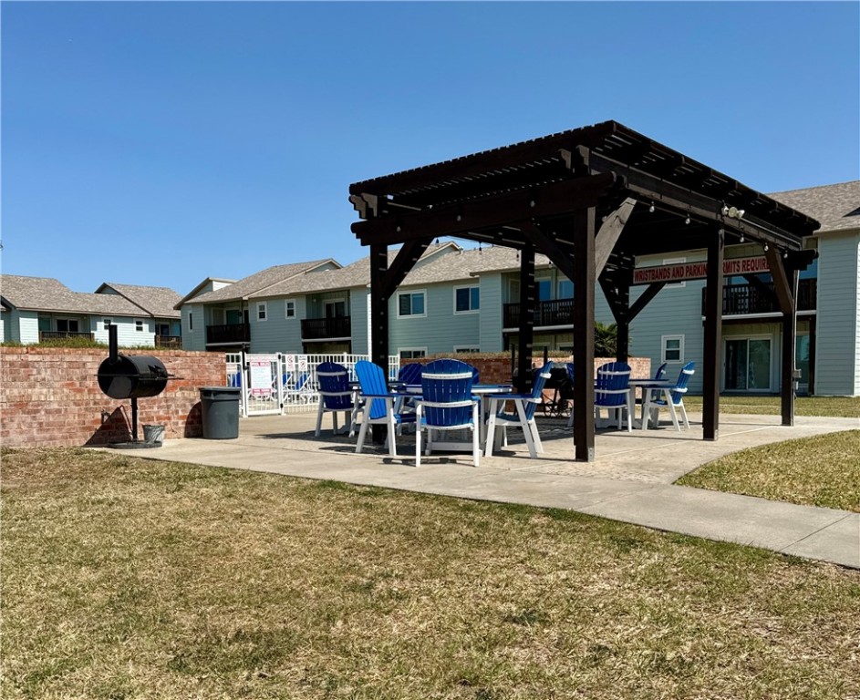 230 Cut-Off Road, Unit B107 Port Aransas, TX 78373 - Photo 24 of 25 a view of a chairs and table in patio