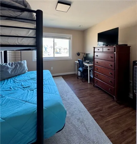 a bed room with furniture and flat screen tv