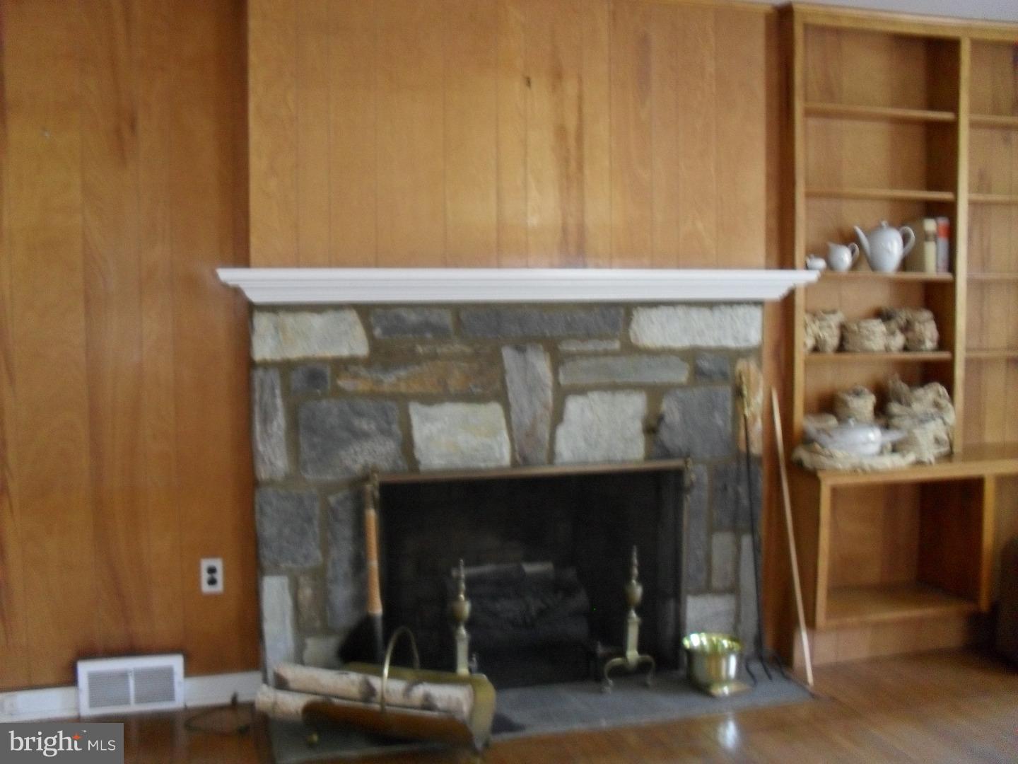 22 Beryl Road Cheltenham, PA 19012 - Photo 12 of 14 a fireplace with a wooden floor