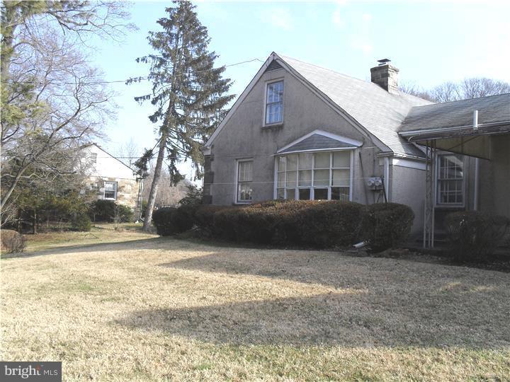 22 Beryl Road Cheltenham, PA 19012 - Photo 4 of 14 a front view of a house with a yard and trees