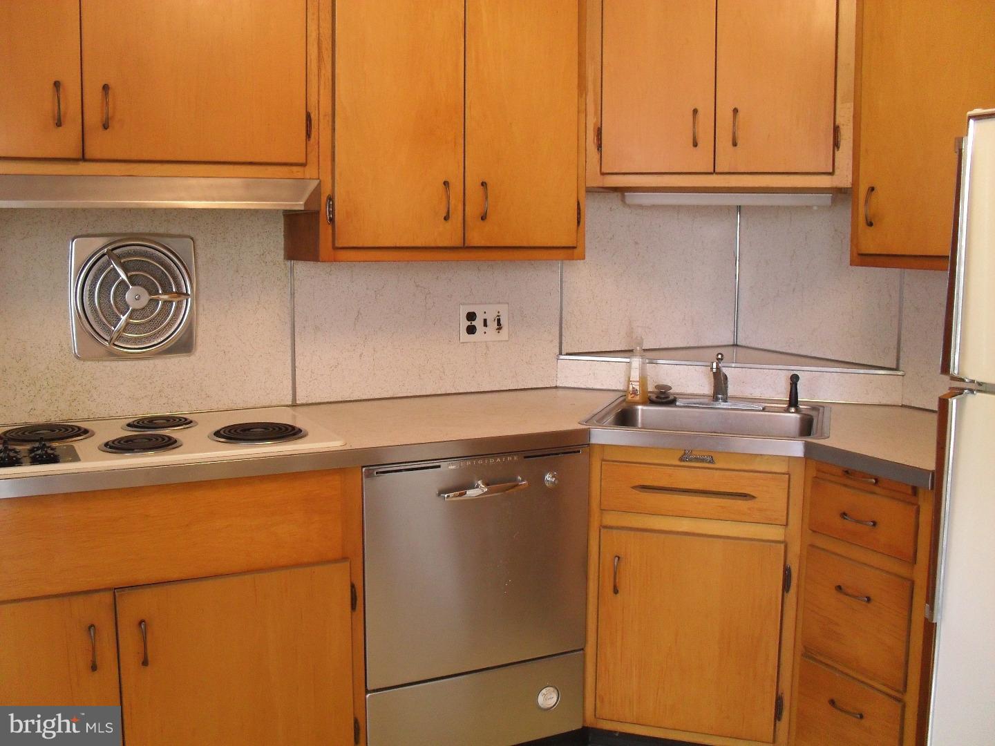 22 Beryl Road Cheltenham, PA 19012 - Photo 8 of 14 a kitchen with stainless steel appliances granite countertop a sink and a refrigerator
