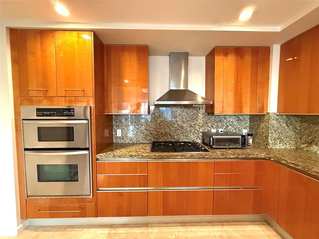 45 Hendricks Isle, Unit 403 Fort Lauderdale, FL 33301 - Photo 7 of 26 a kitchen with stainless steel appliances granite countertop a stove a sink and a microwave