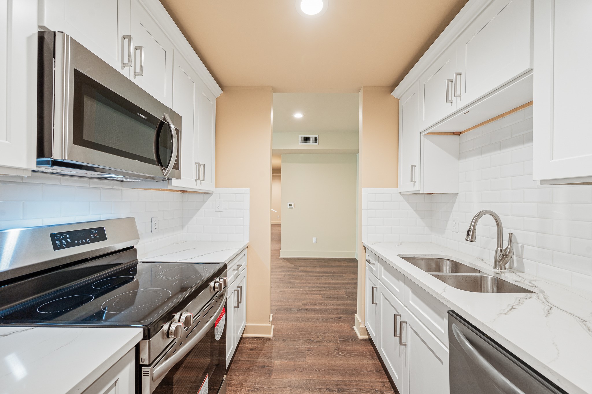 2829 Timmons Lane, Unit 201 Houston, TX 77027 - Photo 16 of 42 a kitchen with stainless steel appliances a stove a sink and a microwave