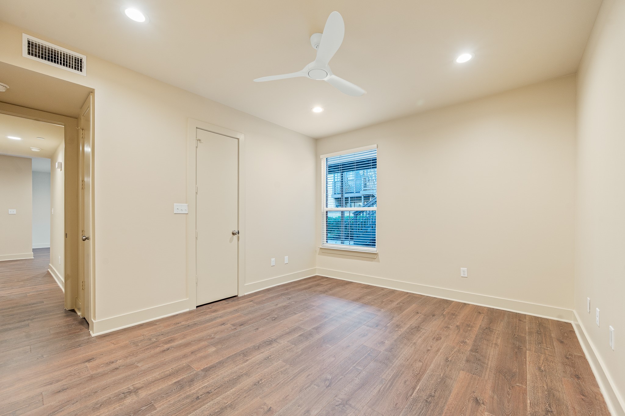 2829 Timmons Lane, Unit 201 Houston, TX 77027 - Photo 23 of 42 an empty room with wooden floor and windows