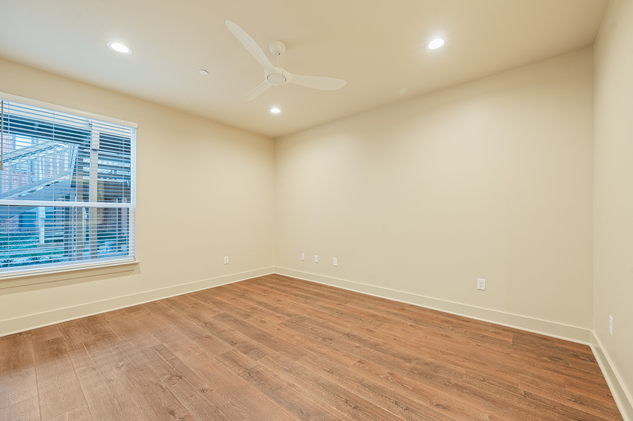 2829 Timmons Lane, Unit 201 Houston, TX 77027 - Photo 27 of 42 an empty room with wooden floor and windows