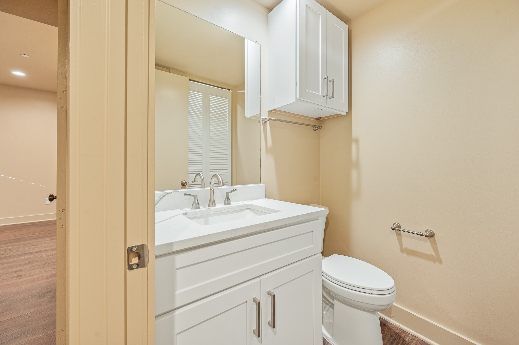 2829 Timmons Lane, Unit 201 Houston, TX 77027 - Photo 29 of 42 a bathroom with a toilet sink vanity and mirror