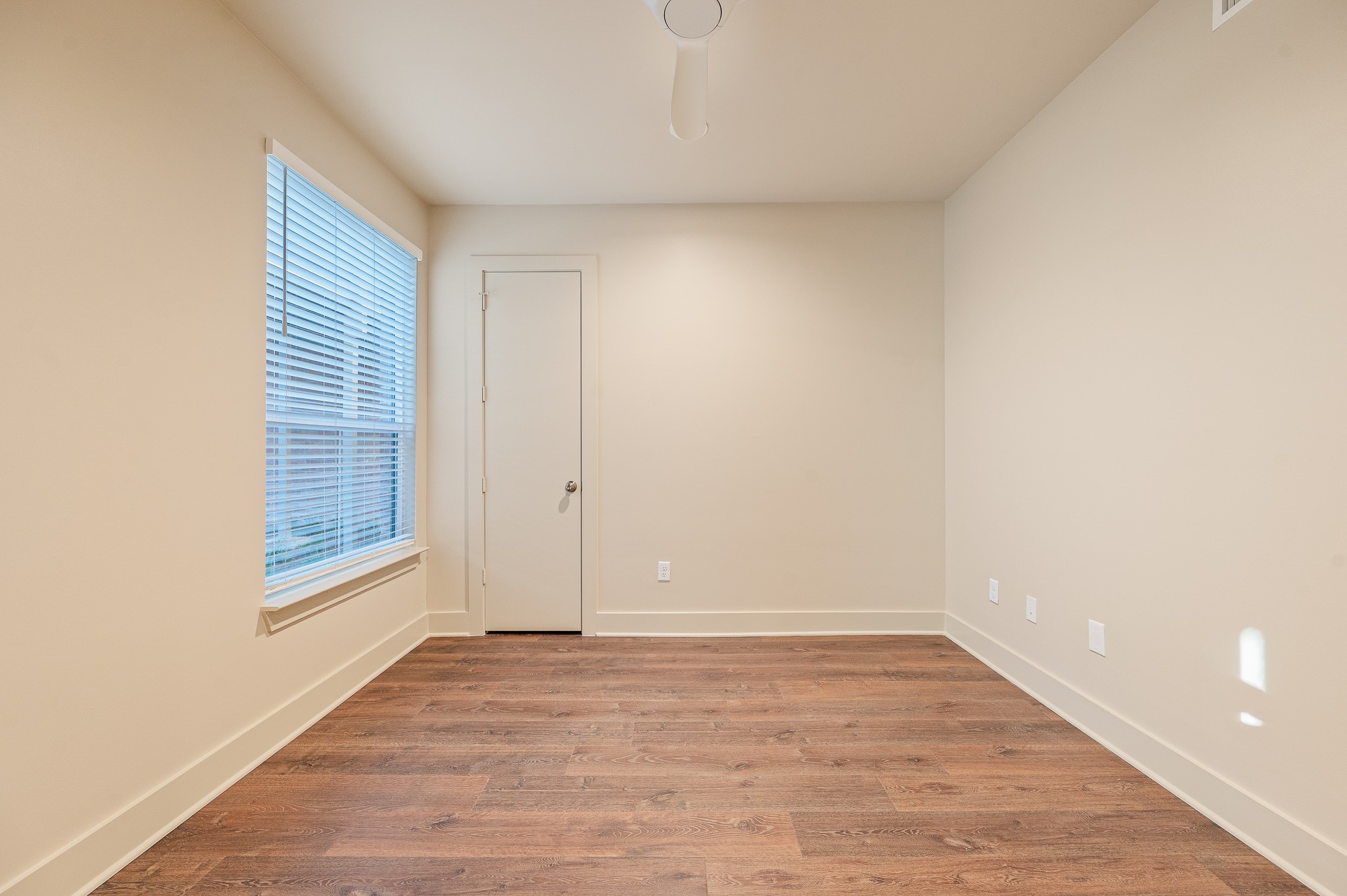 2829 Timmons Lane, Unit 201 Houston, TX 77027 - Photo 30 of 42 a view of an empty room with wooden floor and a window