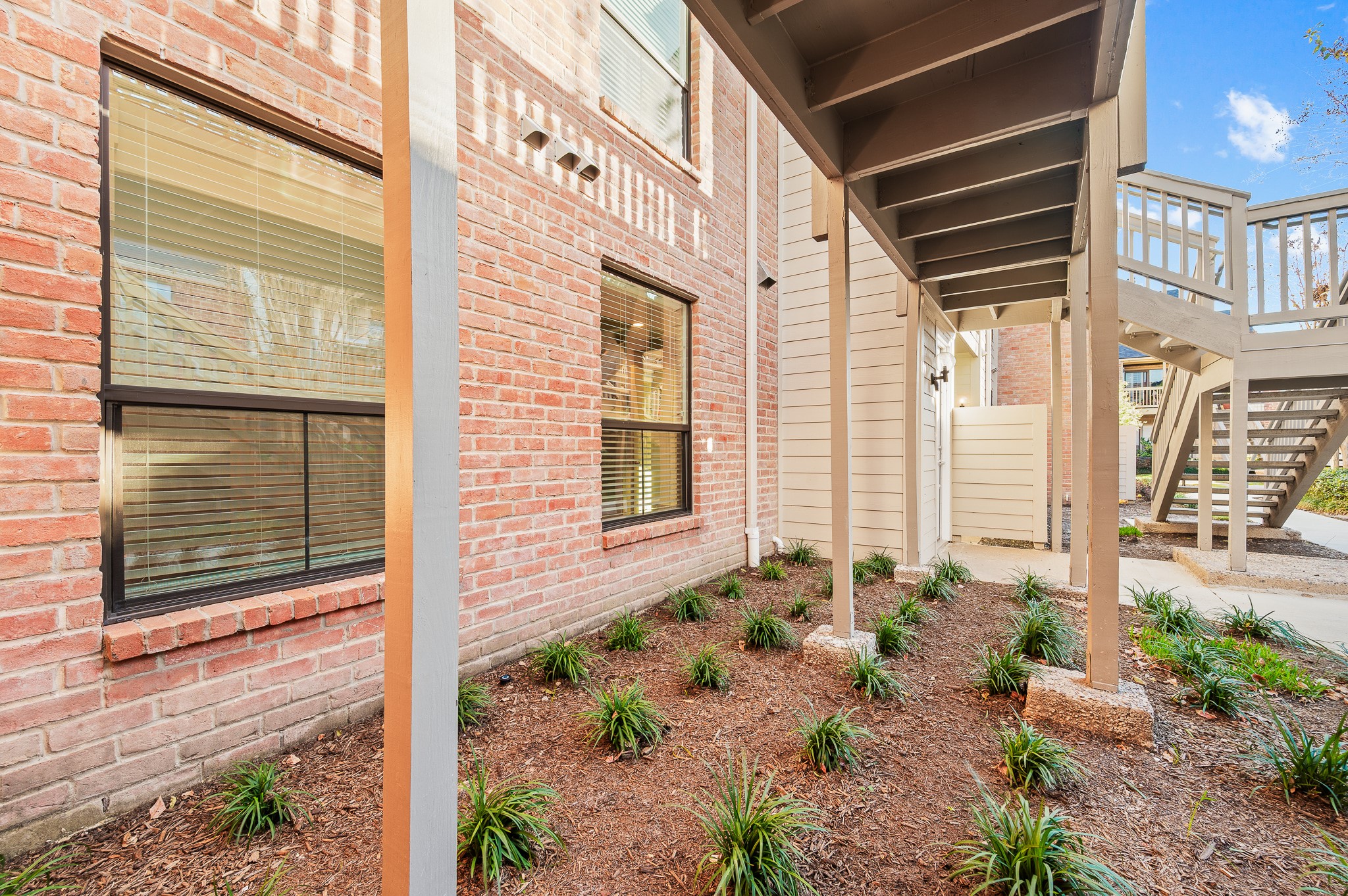 2829 Timmons Lane, Unit 201 Houston, TX 77027 - Photo 4 of 42 a front view of a house with a yard