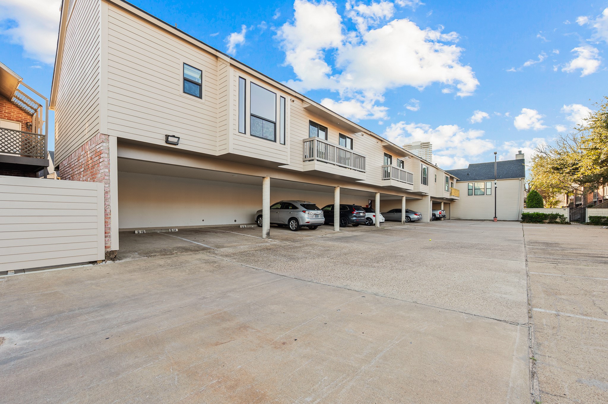 2829 Timmons Lane, Unit 201 Houston, TX 77027 - Photo 41 of 42 a front view of a house with a yard and garage