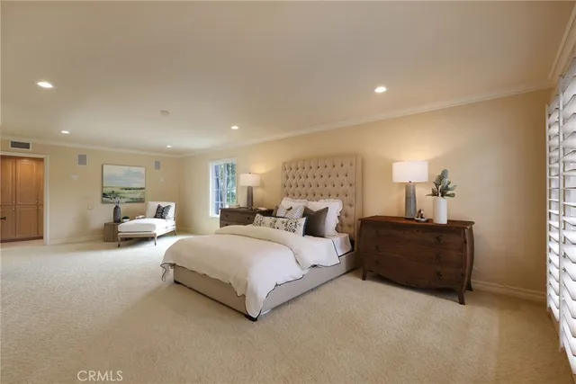 a spacious bedroom with a bed and window