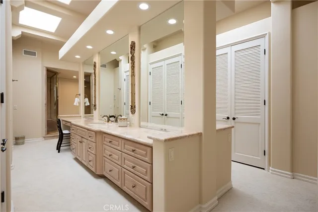 a bathroom with a double vanity sink mirror and double