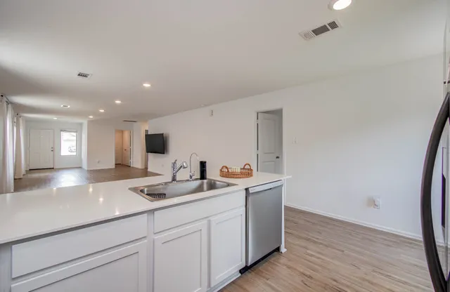 a kitchen with a sink and mirror