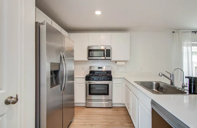 a kitchen with a sink and stainless steel appliances