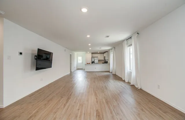 a view of a livingroom with furniture and a flat screen tv