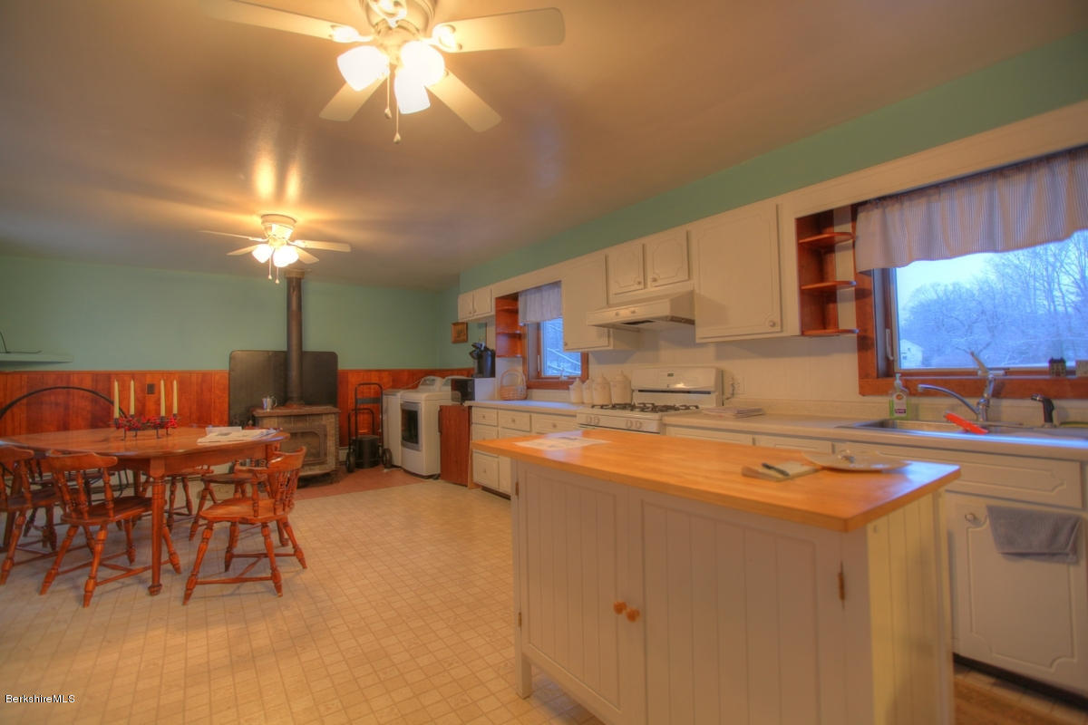 47 Sandisfield Road Sandisfield, MA 01255 - Photo 8 of 25 a kitchen with stainless steel appliances granite countertop a sink dishwasher and cabinets with wooden floor