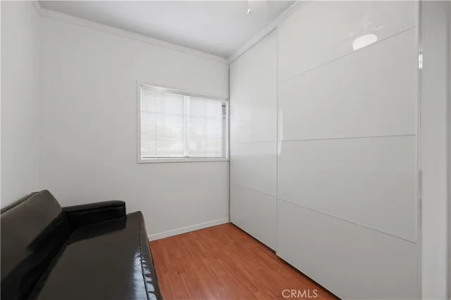 a bed sitting in a room next to a window