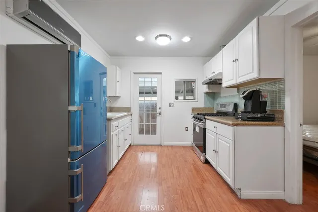 a spacious bathroom with a granite countertop sink and a mirror
