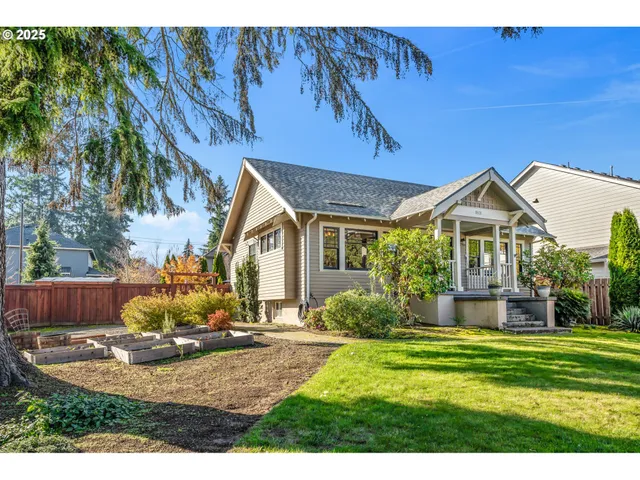 a view of a house with backyard and sitting area