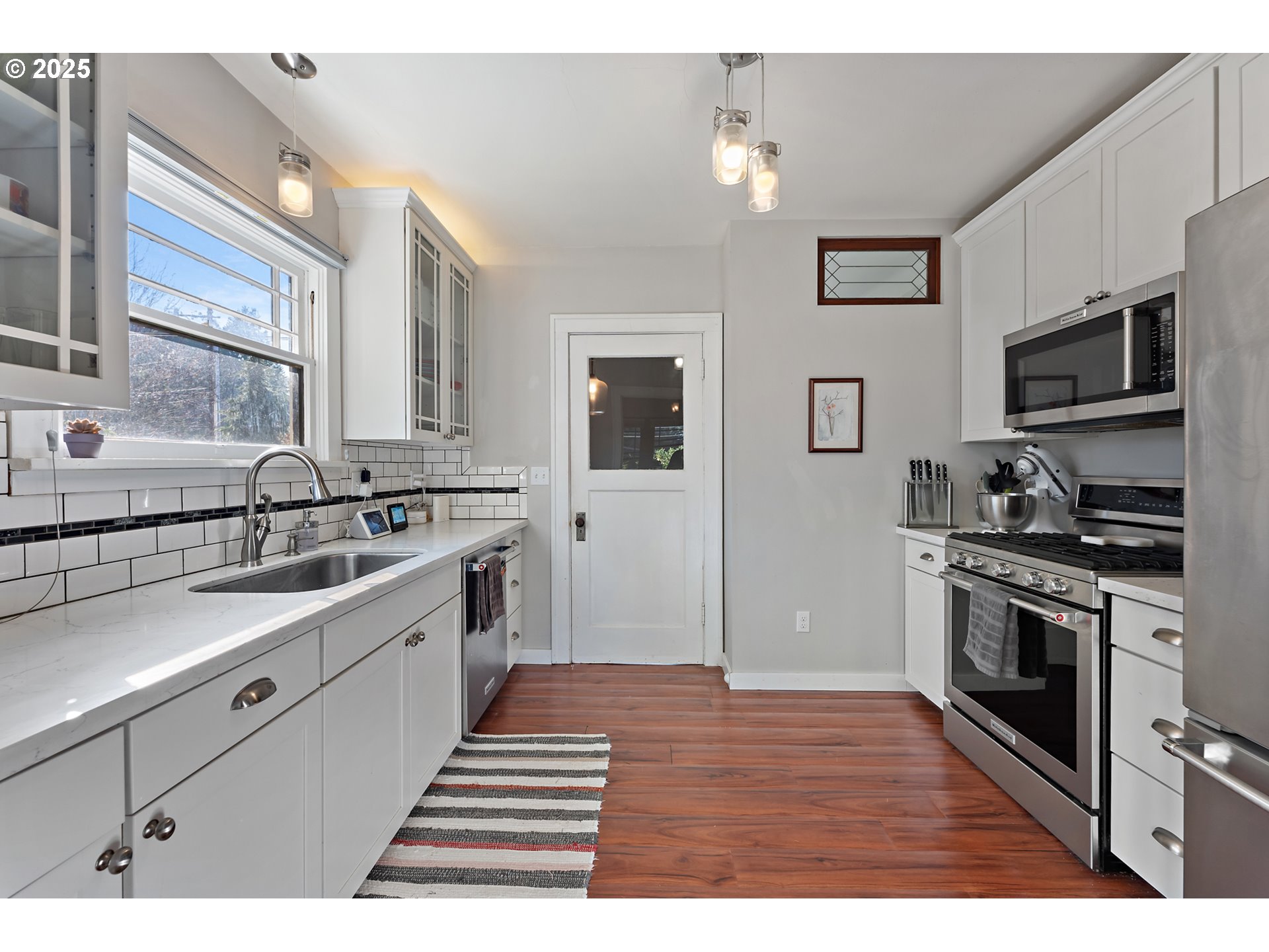 9670 Southwest Frewing Street Portland, OR 97223 - Photo 14 of 40 a kitchen with stainless steel appliances granite countertop a sink stove and refrigerator