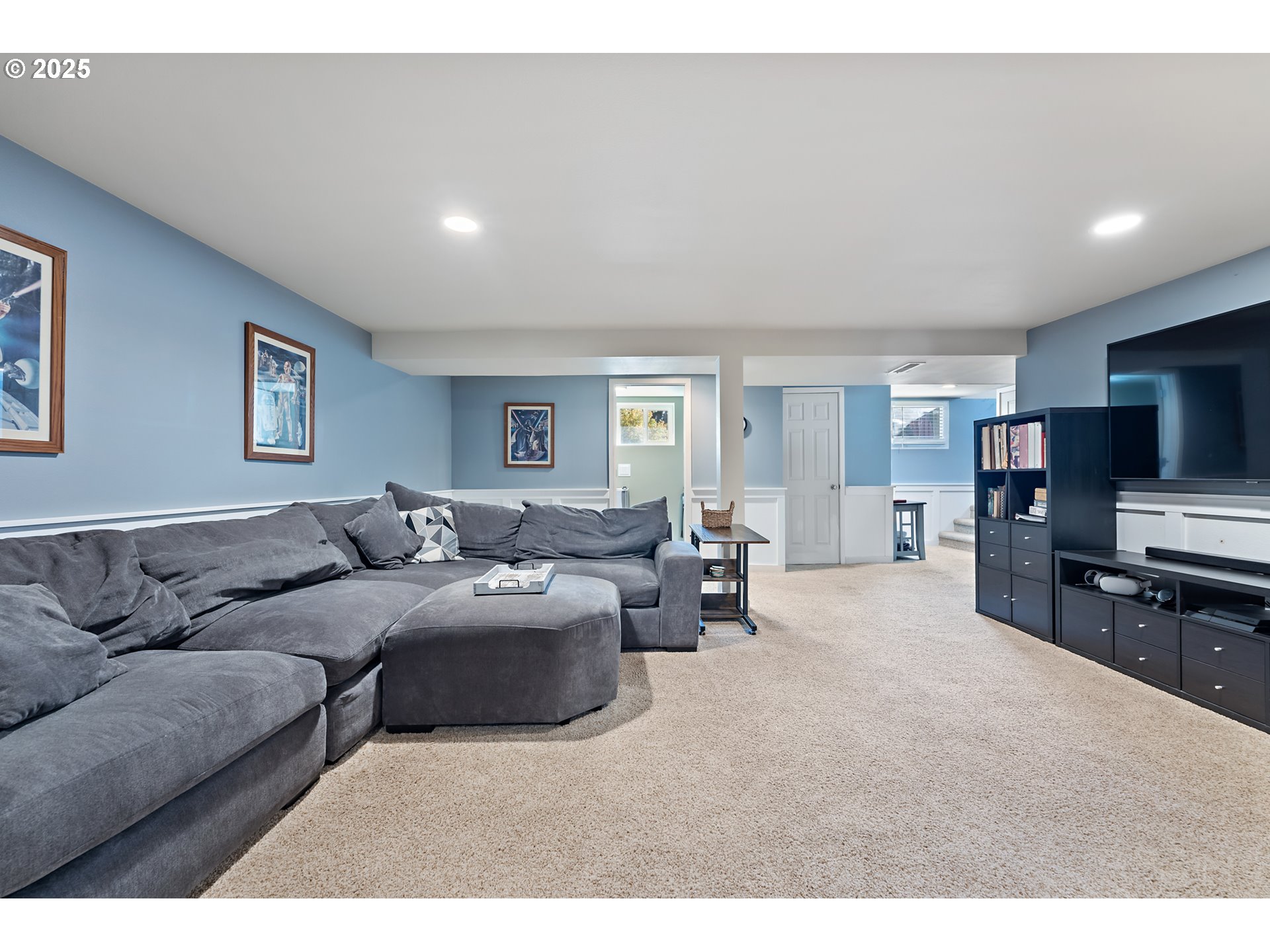 9670 Southwest Frewing Street Portland, OR 97223 - Photo 24 of 40 a living room with furniture and a flat screen tv