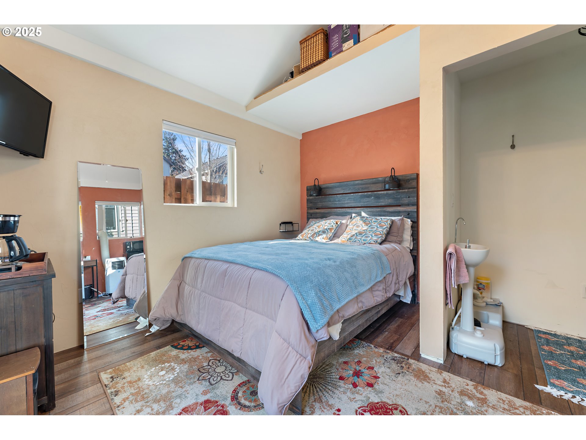 9670 Southwest Frewing Street Portland, OR 97223 - Photo 29 of 40 a bedroom with a bed and a flat screen tv