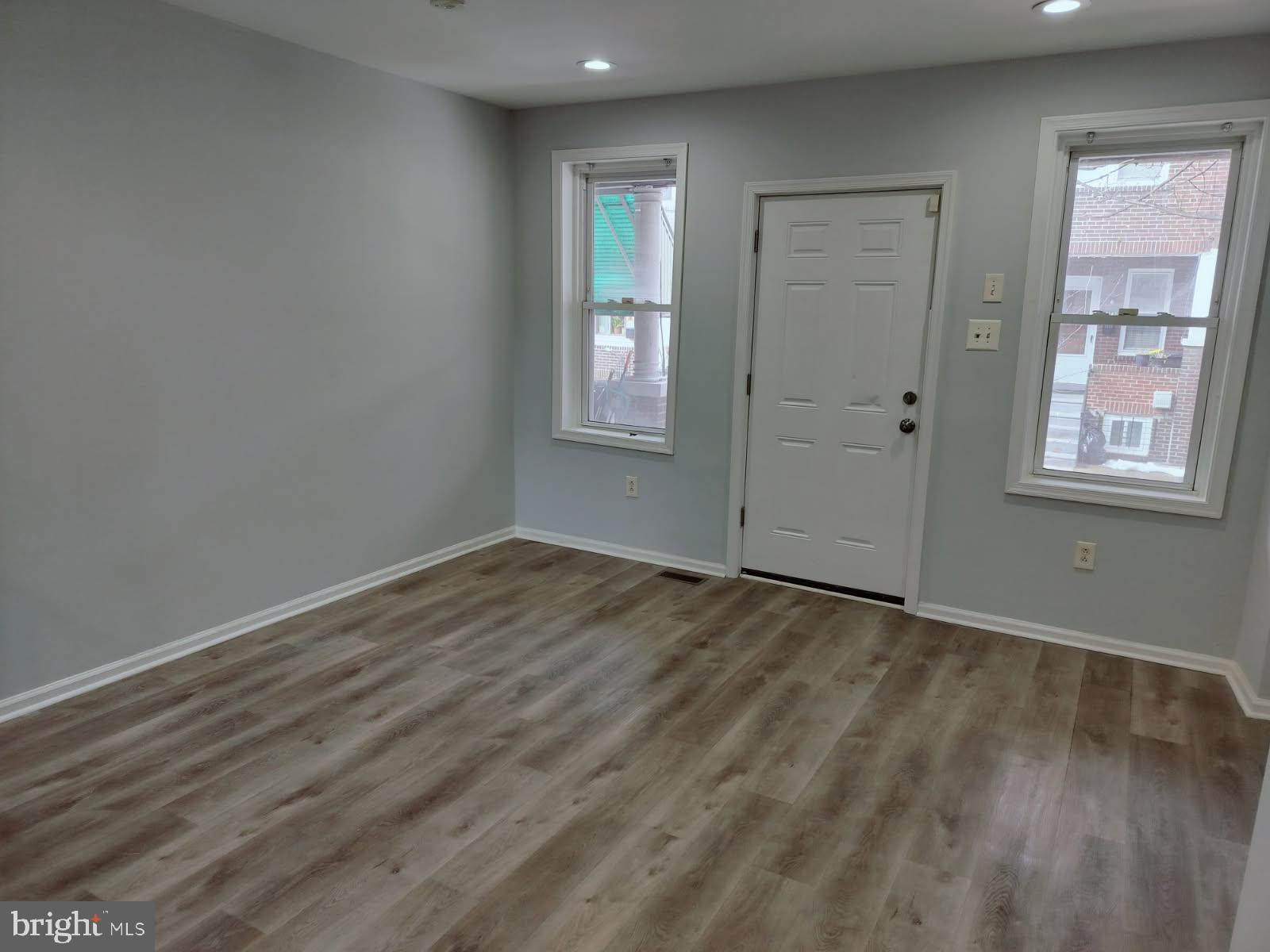 2143 South Beechwood Street Philadelphia, PA 19145 - Photo 2 of 14 an empty room with wooden floor and windows