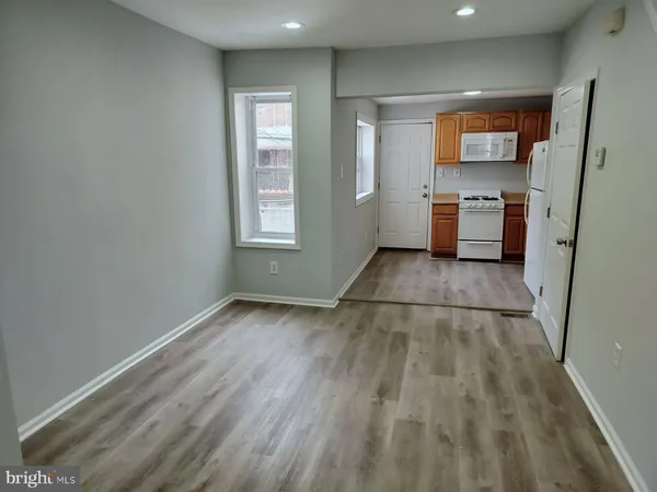 a view of a kitchen with wooden floor and a sink